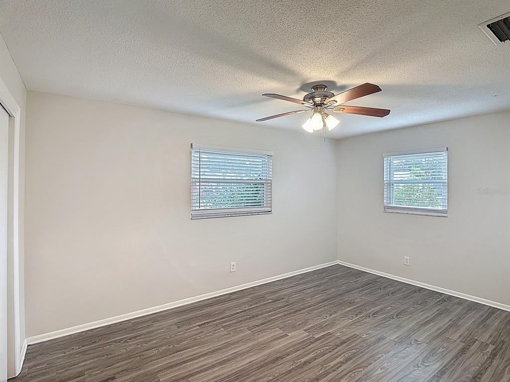 11320 Currie Lane Largo, FL 33774 - Photo 24 of 40 a view of an empty room with wooden floor
