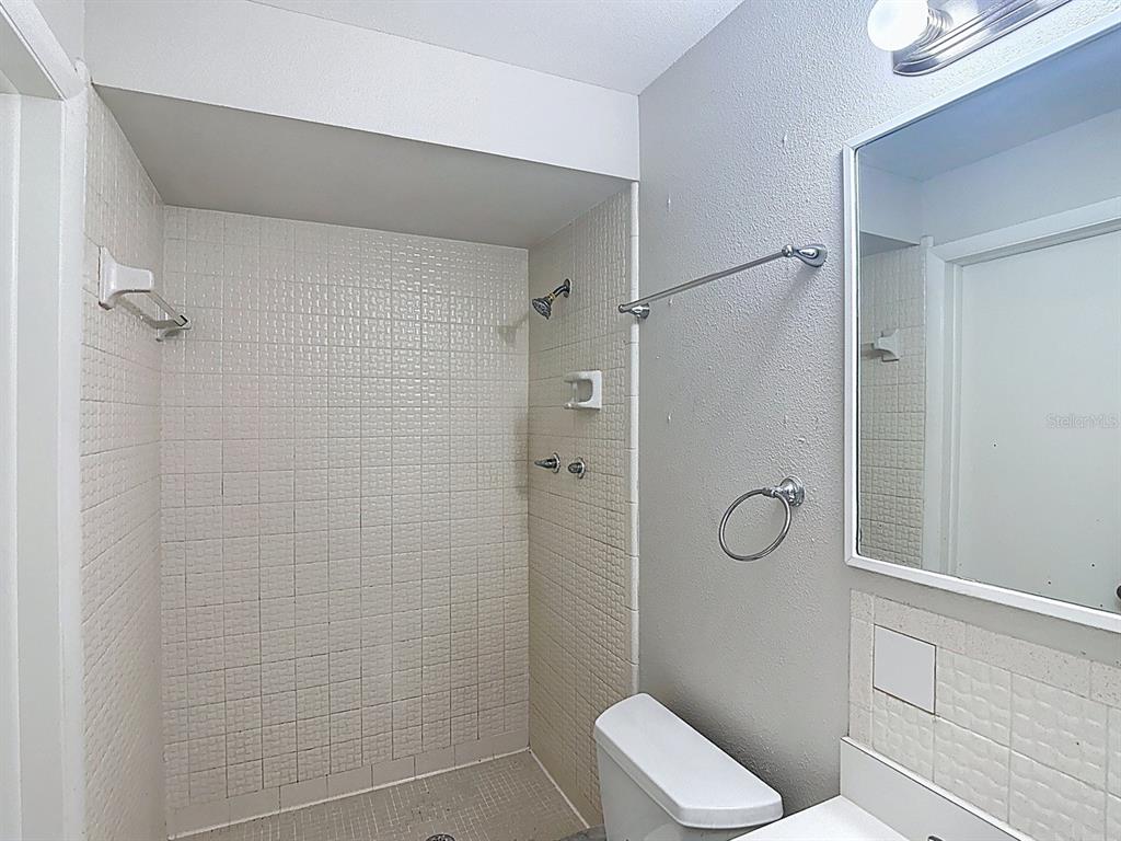 11320 Currie Lane Largo, FL 33774 - Photo 26 of 40 a bathroom with a shower and toilet