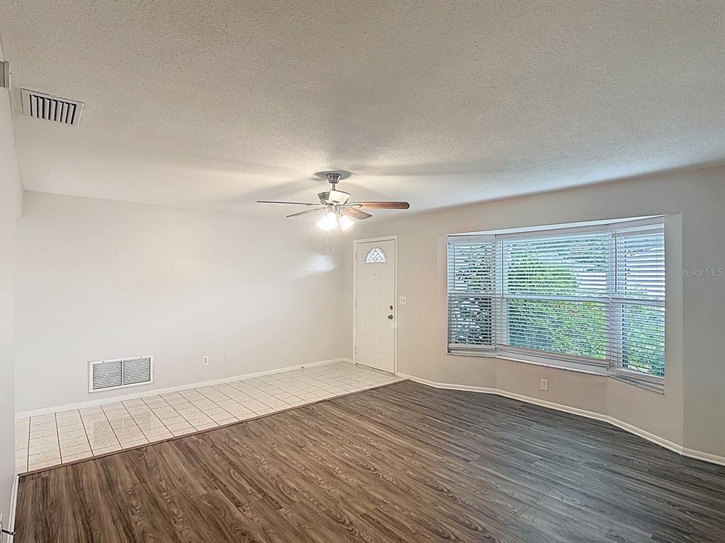 11320 Currie Lane Largo, FL 33774 - Photo 27 of 40 wooden floor in an empty room with a window