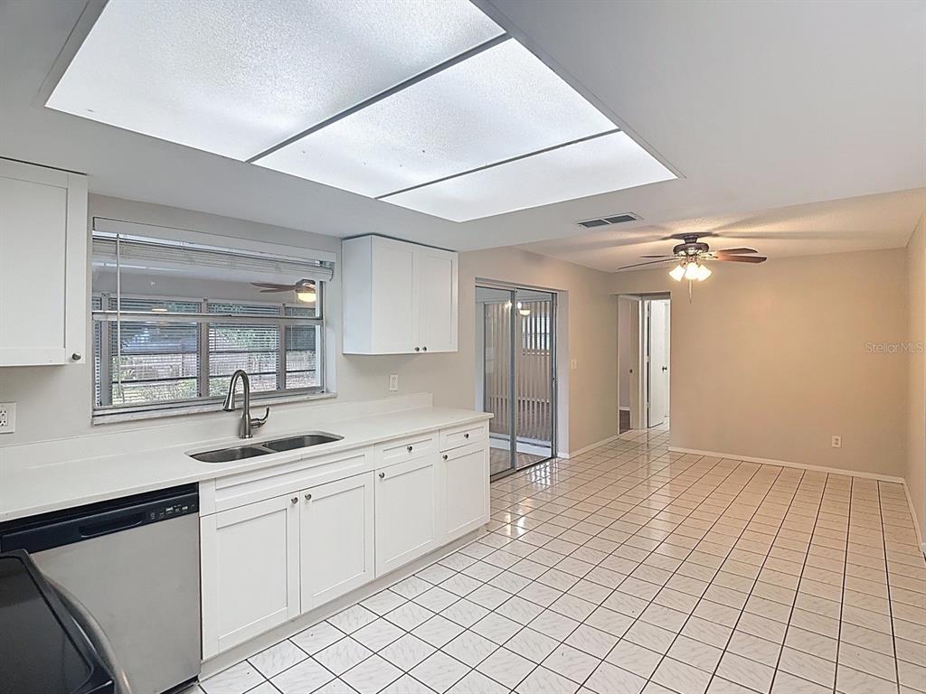 11320 Currie Lane Largo, FL 33774 - Photo 8 of 40 a kitchen with a sink cabinets and window
