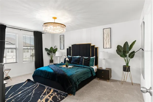 a bedroom with a bed and a potted plant