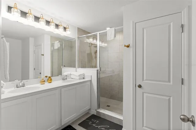 a bathroom with a shower sink and mirror