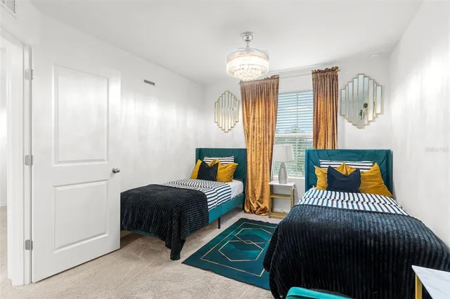 a bedroom with a bed and a chandelier