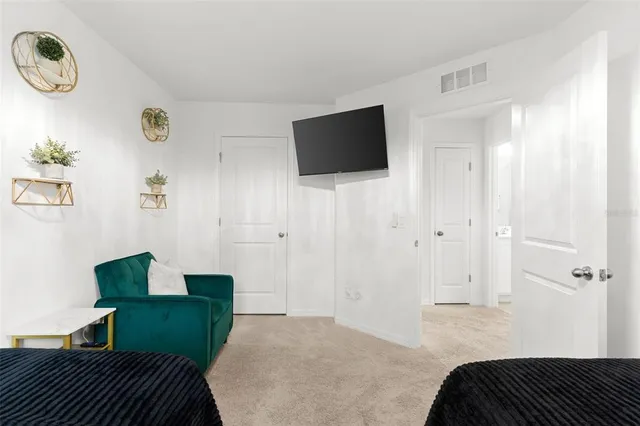 a bedroom with a bed and a television