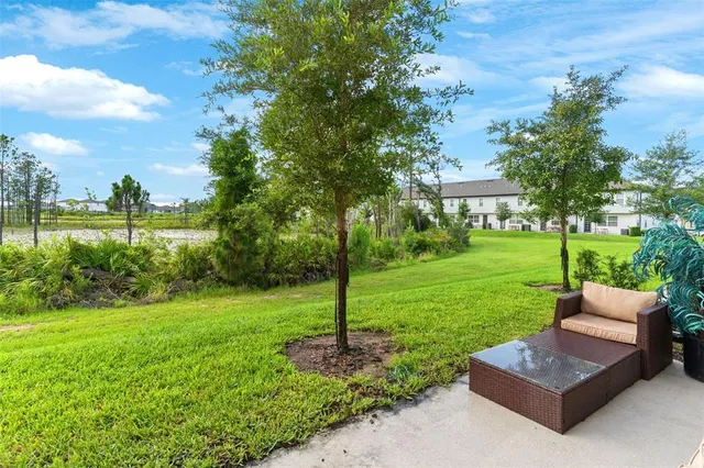 a view of a garden with couches under an umbrella