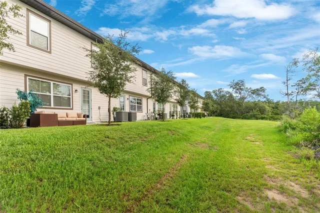 a view of a house with backyard and garden