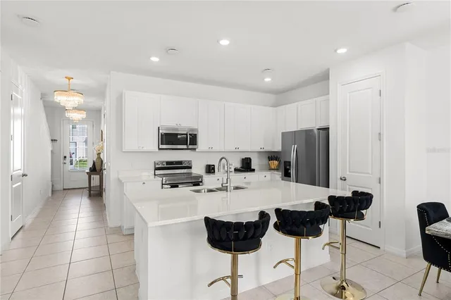 a kitchen with stainless steel appliances granite countertop a refrigerator and a stove top oven