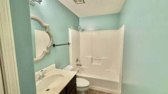 a view of an empty room with a ceiling fan