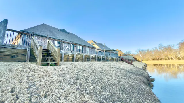 a view of a yard with wooden fence