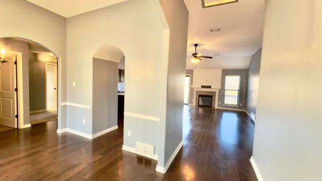 a view of a hallway view with wooden floor and staircase