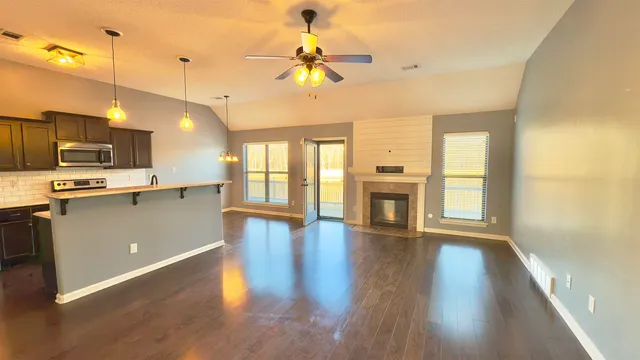 a view of a kitchen with a stove cabinets and wooden floor