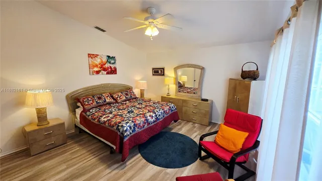 a bedroom with a bed and dresser in it