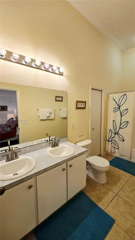 a bathroom with a double vanity sink and a mirror