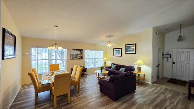 a living room with furniture dining table and a wooden floor