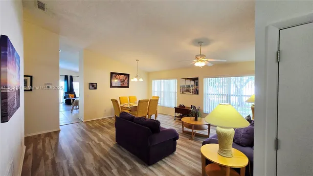 a living room with furniture and a lamp