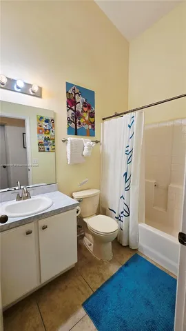 a bathroom with a toilet sink and shower