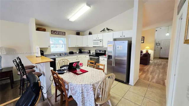 a kitchen with stainless steel appliances a refrigerator sink microwave and cabinets