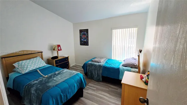 a bedroom with bed and a window