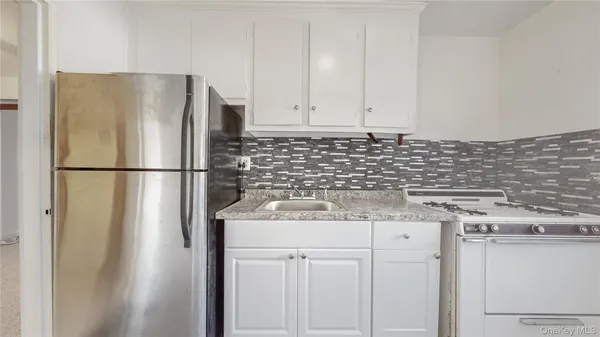 a kitchen with appliances a sink and cabinets