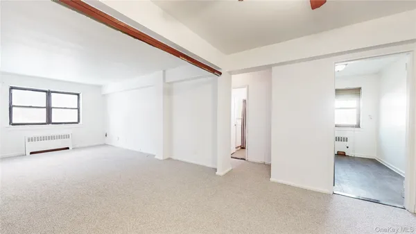 an empty room with windows and closet