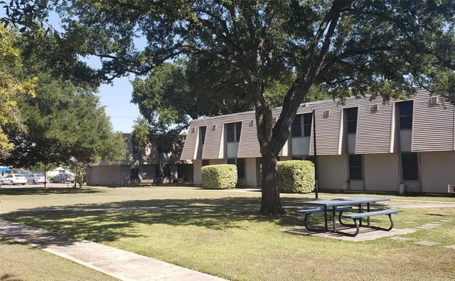 a view of a house with swimming pool and sitting area