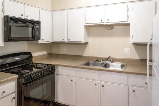 a kitchen with a sink and cabinets