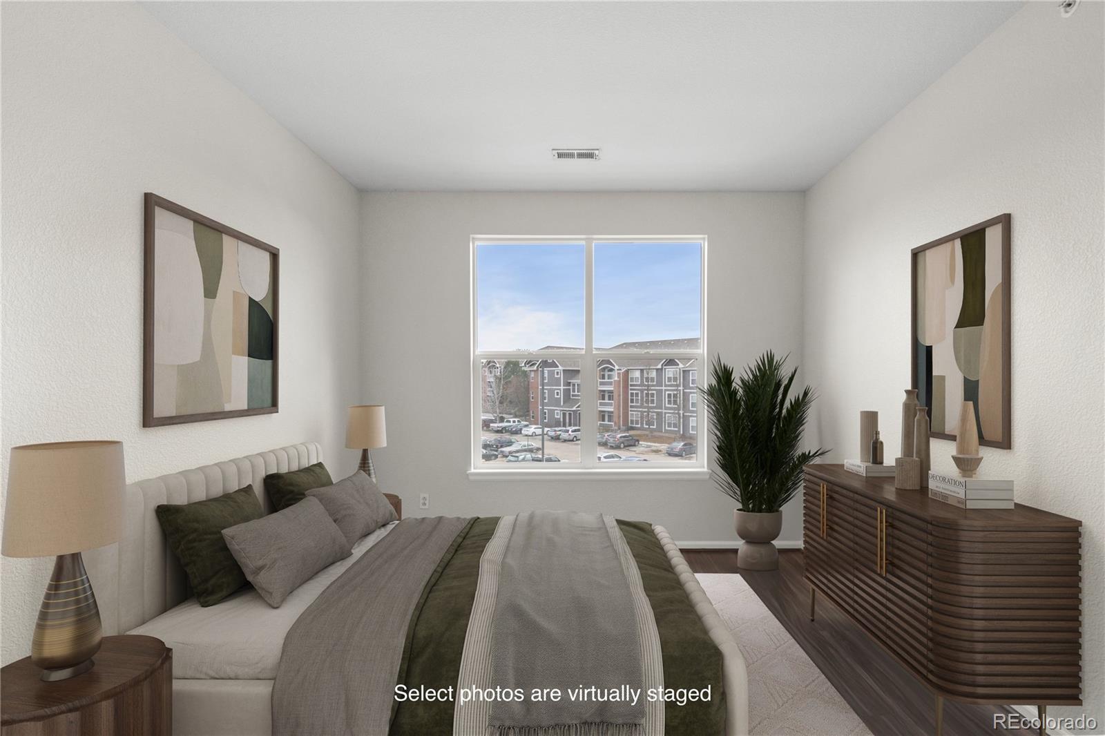 14251 East 1st Drive, Unit 305 Aurora, CO 80011 - Photo 14 of 22 a bedroom with a large bed and a window