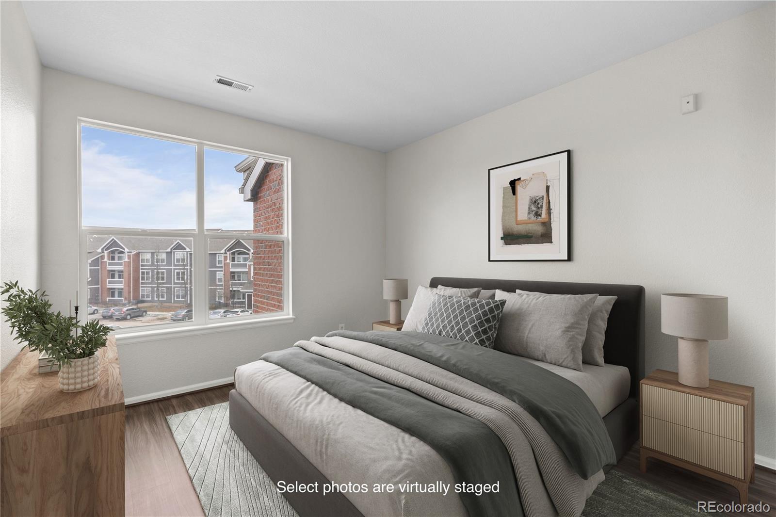 14251 East 1st Drive, Unit 305 Aurora, CO 80011 - Photo 16 of 22 a bedroom with a large bed and a window