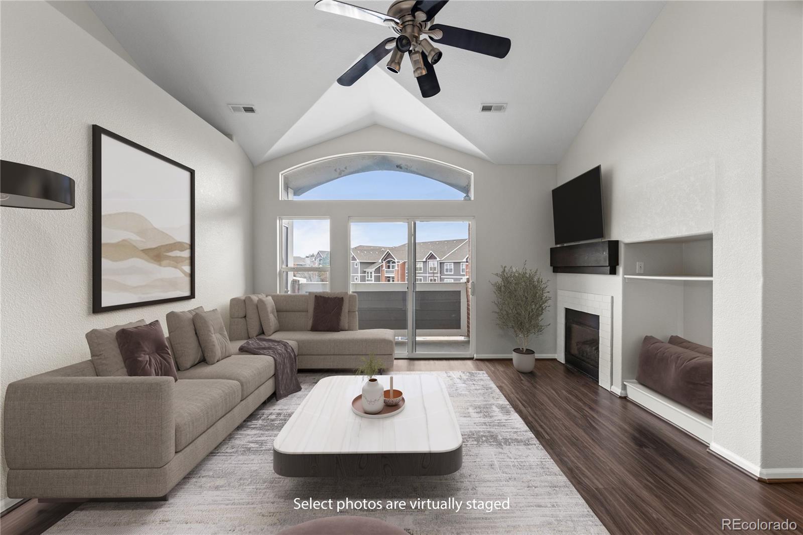14251 East 1st Drive, Unit 305 Aurora, CO 80011 - Photo 2 of 22 a living room with furniture and a fireplace