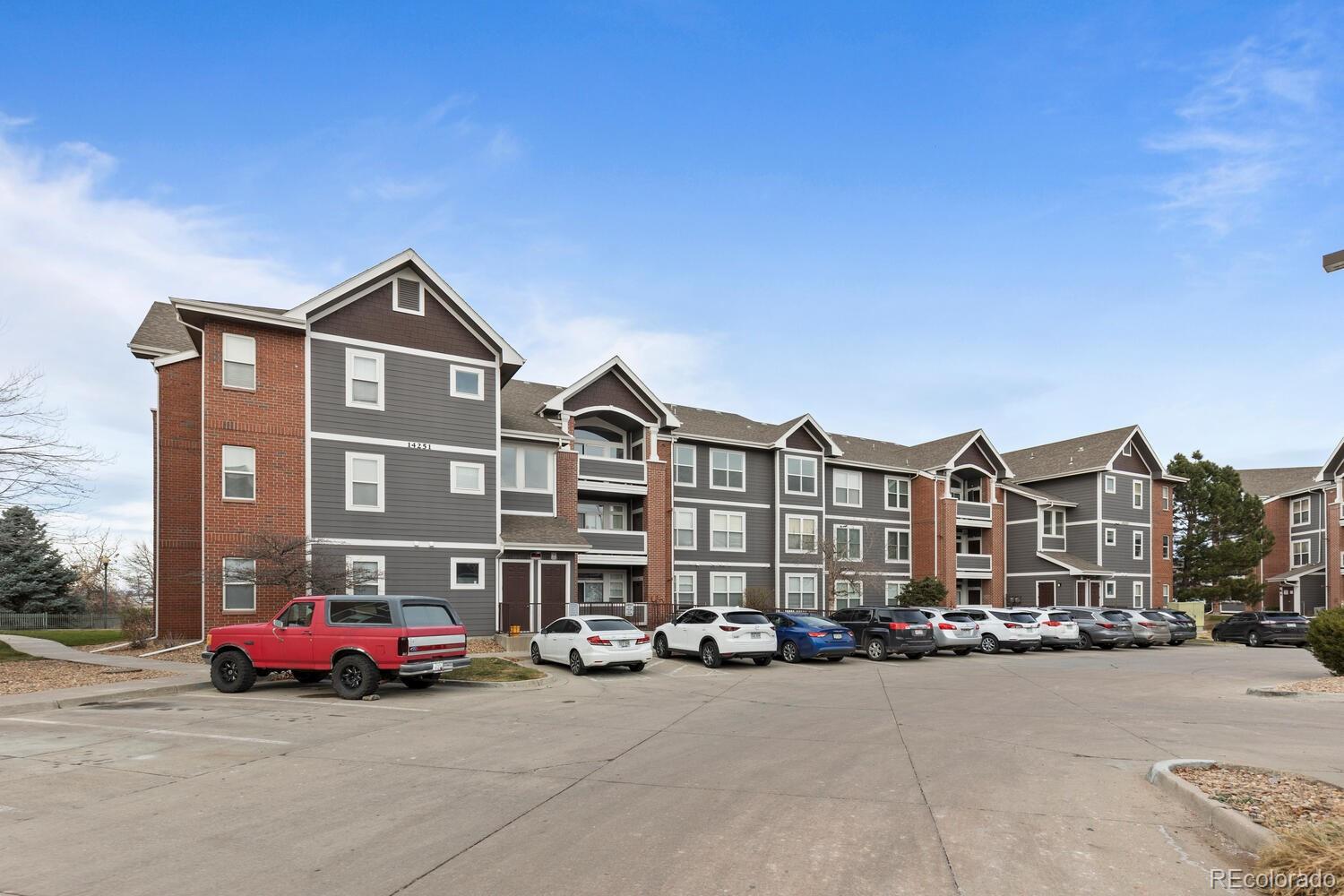 14251 East 1st Drive, Unit 305 Aurora, CO 80011 - Photo 22 of 22 a car parked in front of a house