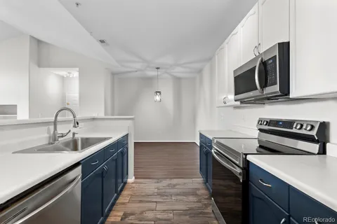 a kitchen with stainless steel appliances granite countertop a sink stove and microwave