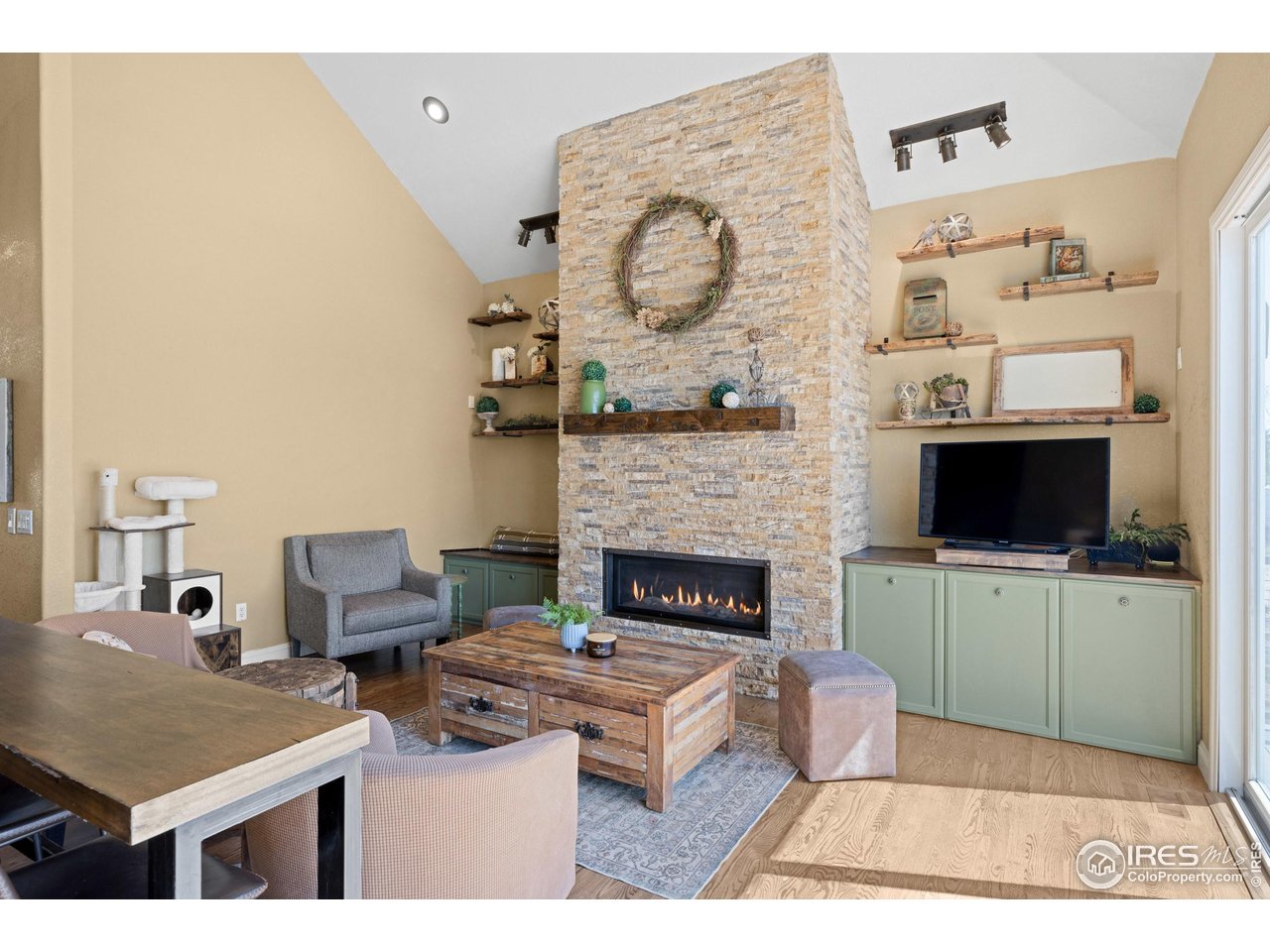 111 Hunter's Cove Road Mead, CO 80542 - Photo 3 of 40 Open living room with vaulted ceiling and gas fireplace