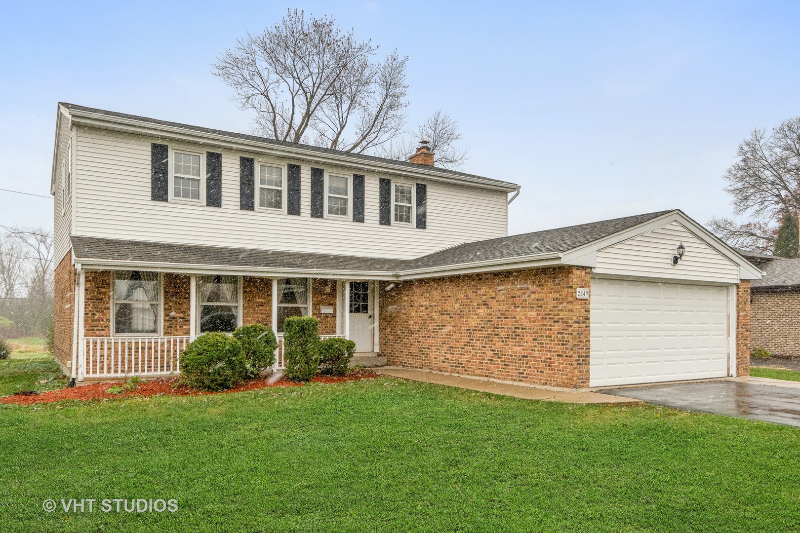 2849 Willow Road Homewood, IL 60430 - Photo 1 of 15 a front view of a house with a garden