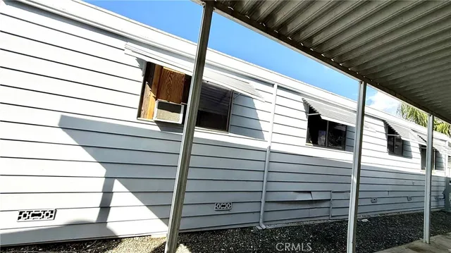 a view of a house with a wooden fence