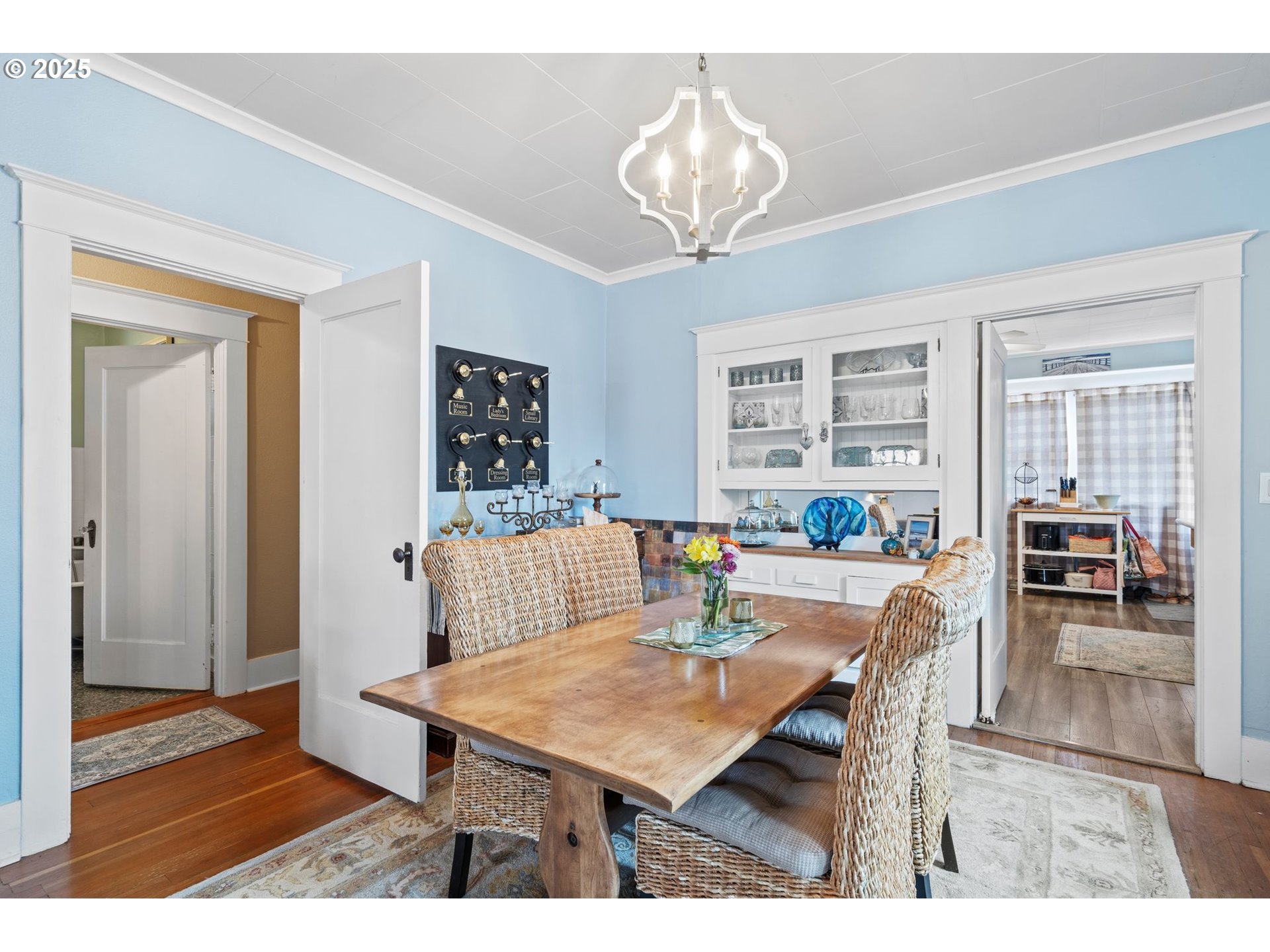1306 B Street Washougal, WA 98671 - Photo 11 of 32 a dining room with wooden floor and chandelier