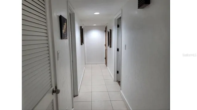 a view of a hallway with a bathroom