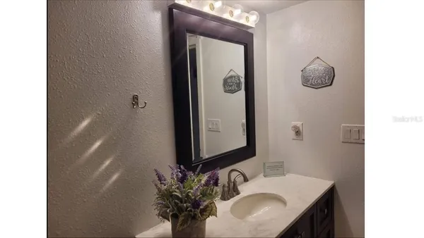 a bathroom with a sink a mirror and vanity