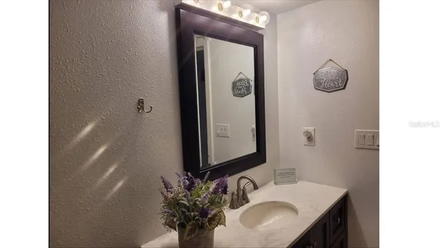 a bathroom with a sink a mirror and vanity