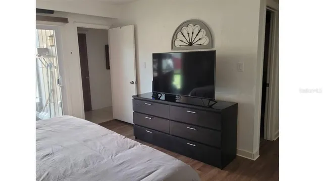 a bedroom with a bed and a flat screen tv