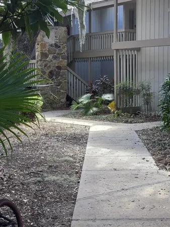 a pathway of a house with wooden fence