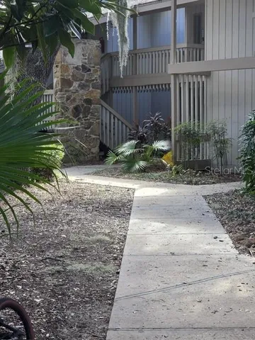 a pathway of a house with wooden fence