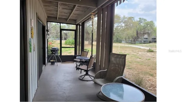 a view of a room with gym equipment and floor to ceiling windows