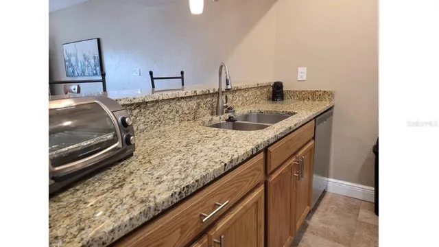 a kitchen with sink and mirror