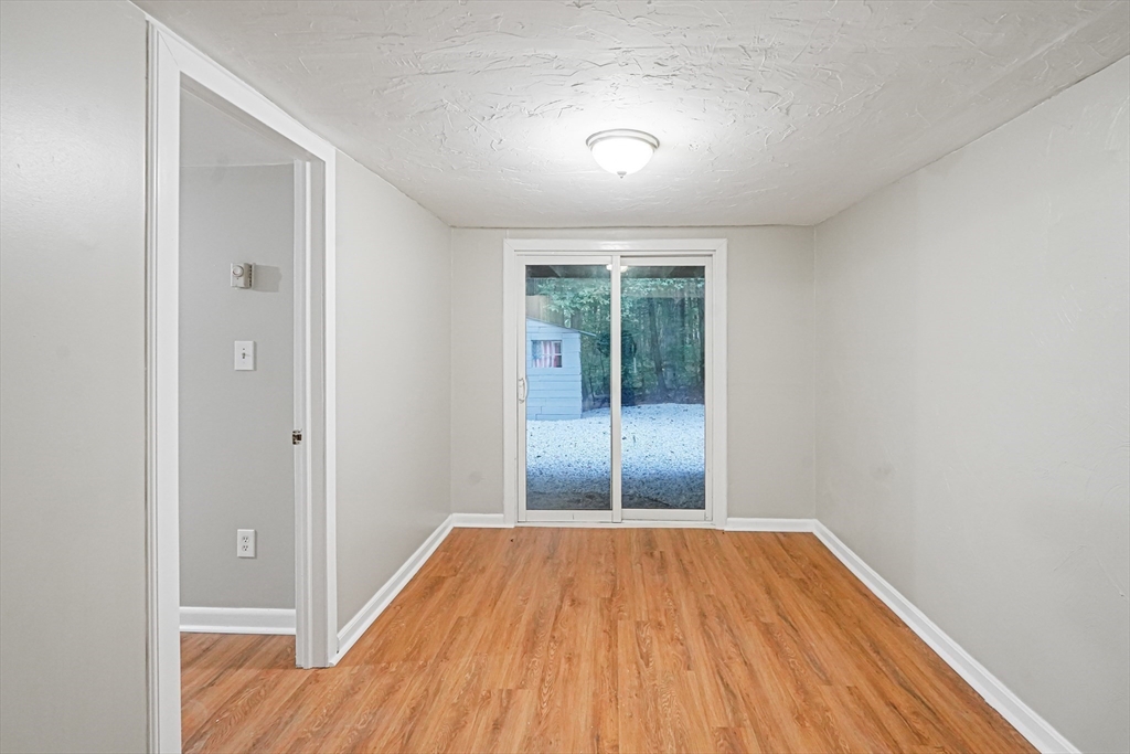 5-9 Debra Lane Bellingham, MA 02019 - Photo 12 of 25 wooden floor in an empty room with a window