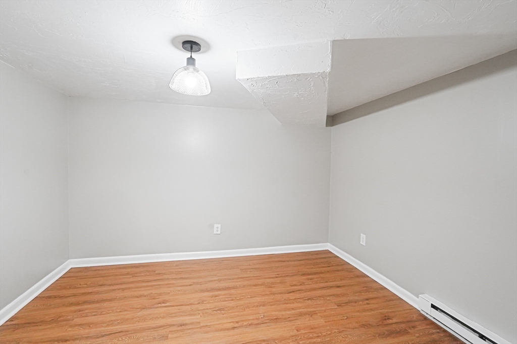 5-9 Debra Lane Bellingham, MA 02019 - Photo 14 of 25 a view of empty room with wooden floor