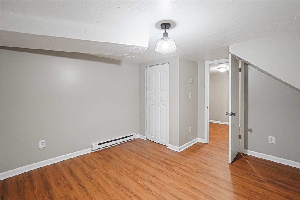 5-9 Debra Lane Bellingham, MA 02019 - Photo 15 of 25 a view of a room with wooden floor and white walls