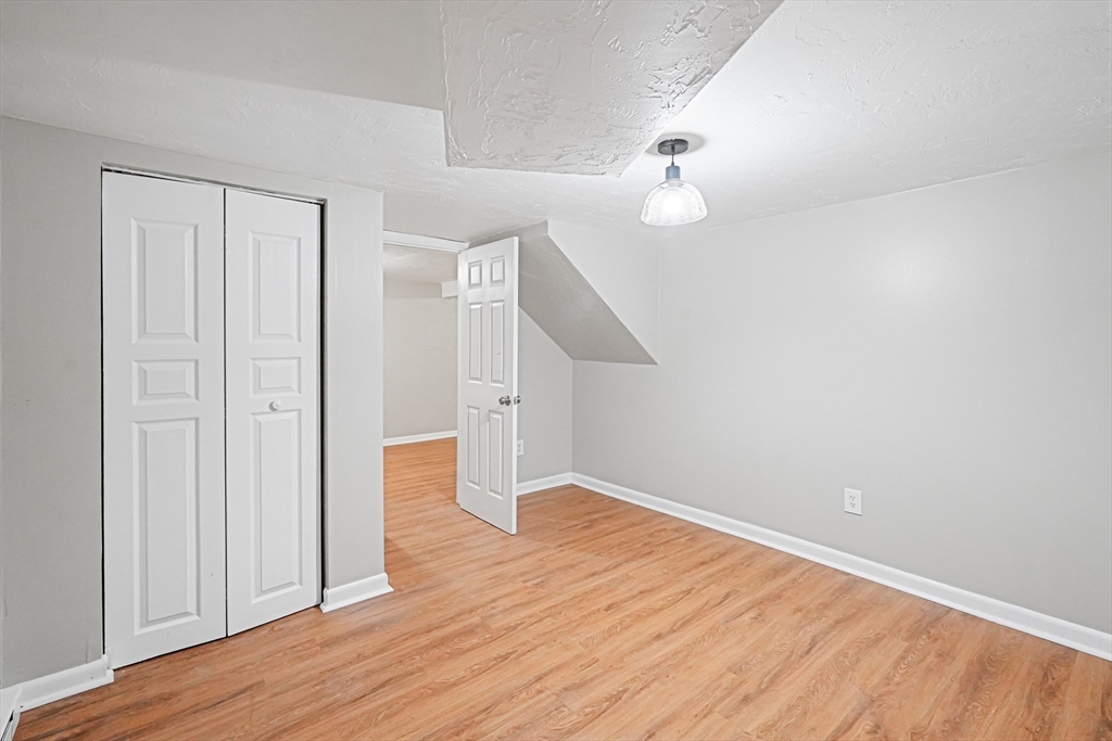5-9 Debra Lane Bellingham, MA 02019 - Photo 16 of 25 a view of an empty room with wooden floor