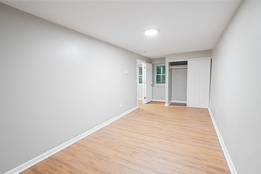 5-9 Debra Lane Bellingham, MA 02019 - Photo 20 of 25 a view of empty room with wooden floor