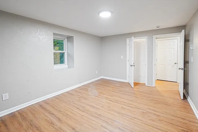 a view of an empty room with wooden floor