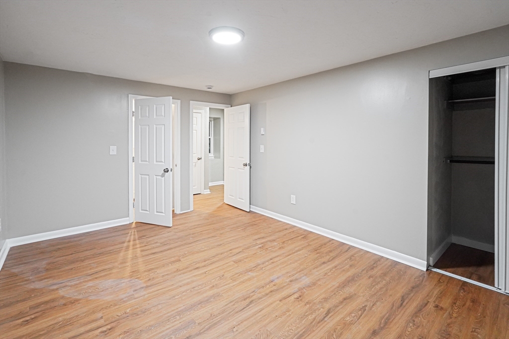 5-9 Debra Lane Bellingham, MA 02019 - Photo 23 of 25 a view of an empty room with wooden floor